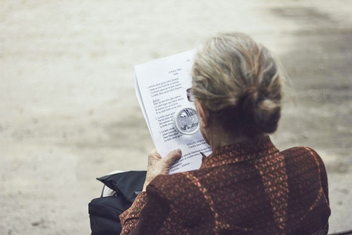 older lady reading outside 